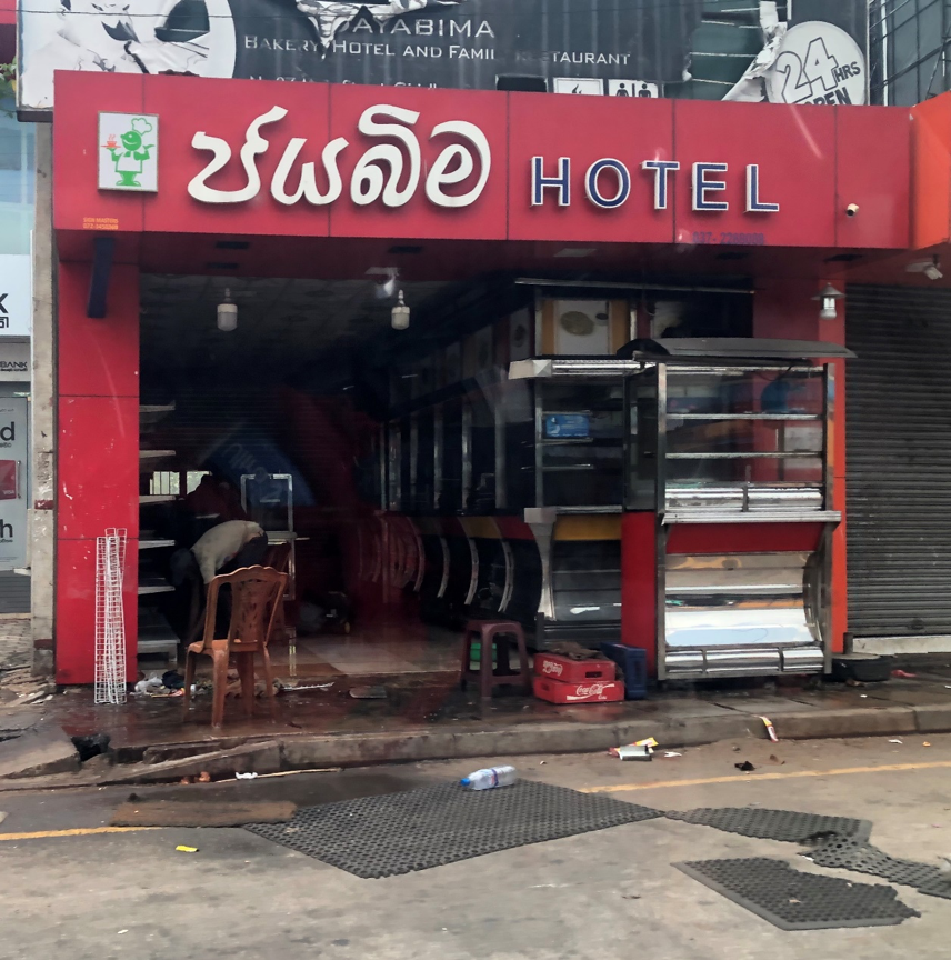 Muslim proprietor cleans up after reprisal attacks May 14, 2019. Credit: Page Fortna